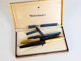 two pens in a box on a white surface