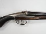a gun that is on display on a white surface