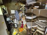 a messy room with a lot of clutter on the floor