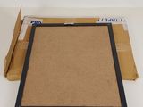 an open cardboard box with a piece of cardboard on top of it
