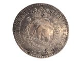 a silver coin with a picture of a bull on it