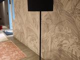 a lamp that is on the floor next to a rug