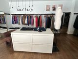 an image of a clothing store with clothes on display