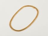 a gold chain bracelet on a white background
