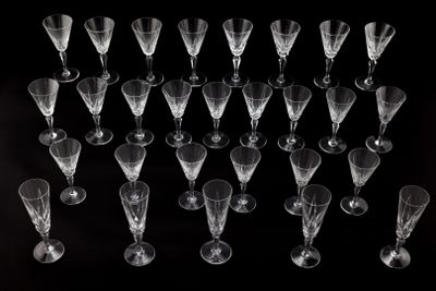 a lot of empty wine glasses on a black table