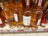 many bottles of wine sitting on a shelf in a store