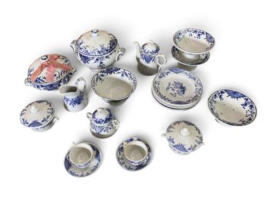 many pieces of blue and white porcelain on a white surface