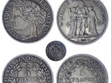 a group of five silver coins sitting on top of each other