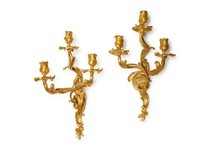 pair of antique brass wall sconces on a white background