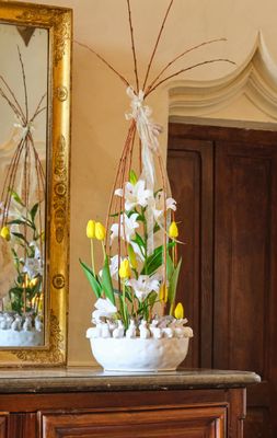 a vase with flowers on top of a dresser