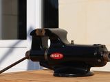 an image of a vise on a table outside