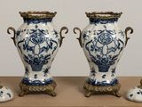two blue and white vases sitting on a table