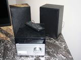 two speakers and a remote sitting on a table