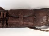 brown leather shotgun case on white background with brown leather belt