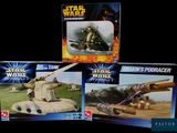 three star wars action figures on display in a display case