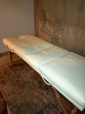 une photo d'une table de massage dans un coin d'une pièce