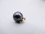 a close up of a black pearl on a white surface