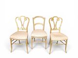 a set of four chairs with gold leaf back and upholstered seats