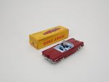 a toy car and a box of cigarettes on a white surface