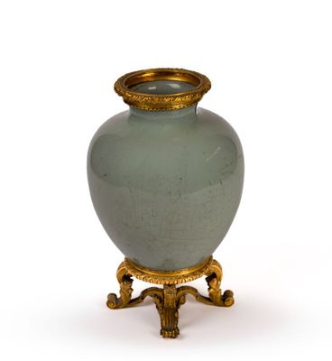 a vase that is sitting on a stand on a white surface