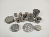 some silver metal objects are sitting on a white surface