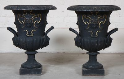 two black vases with gold designs on them