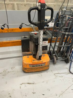 a forklift that is sitting on the floor in a warehouse