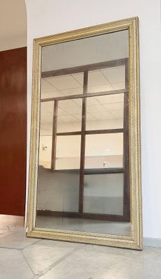 un grand miroir posé sur le sol d'une pièce