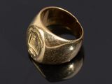 a close up of a gold ring on a black surface