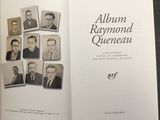 an open book with a picture of a group of men on it
