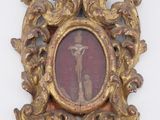 a gold frame with a picture of a man and a dog