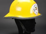 a close up of a yellow fireman ' s helmet on a mannequin head