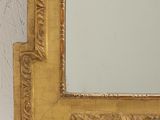 a mirror that is on the wall next to a vase