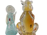 two glass figurines that are sitting next to each other