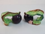 two figurines that are sitting on a table