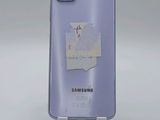 a close up of the back of a purple samsung galaxy s20 with a sticker on it
