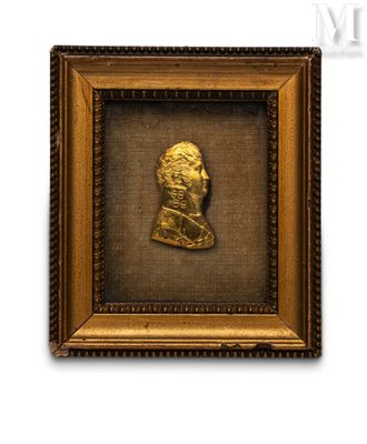 a close up of a gold framed picture of a man ' s head