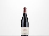 a bottle of red wine sitting on top of a table