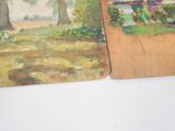 two paintings of a park and a bench on a table