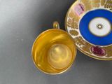 a cup and saucer sitting next to each other on a table