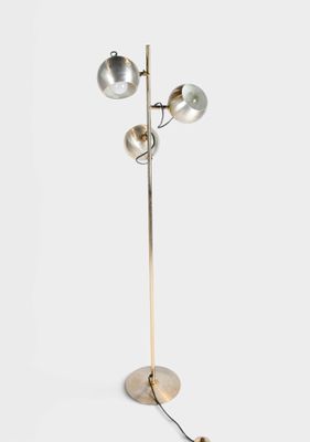 a metal floor lamp with three lamps and a wooden base