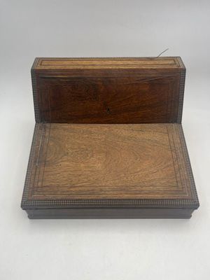 an old wooden box sitting on top of a white surface