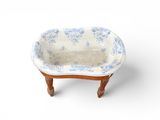 a small blue and white bathtub on a wooden stand