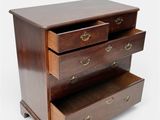 a wooden chest of drawers with three drawers on each side