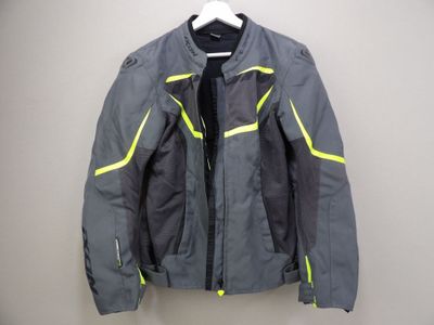 a close up of a motorcycle jacket hanging on a hanger