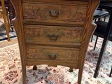 une petite commode en bois posée sur un tapis
