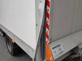 a white truck with a red stripe on the back of it