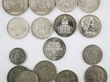 an image of a bunch of coins sitting on top of a white surface