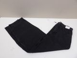a pair of black jeans sitting on top of a white table