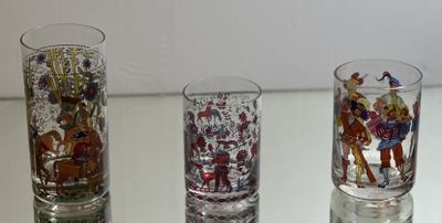 three glass vases sitting on a table with different designs on them